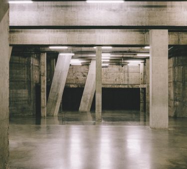 brown wooden floor with white concrete pillar