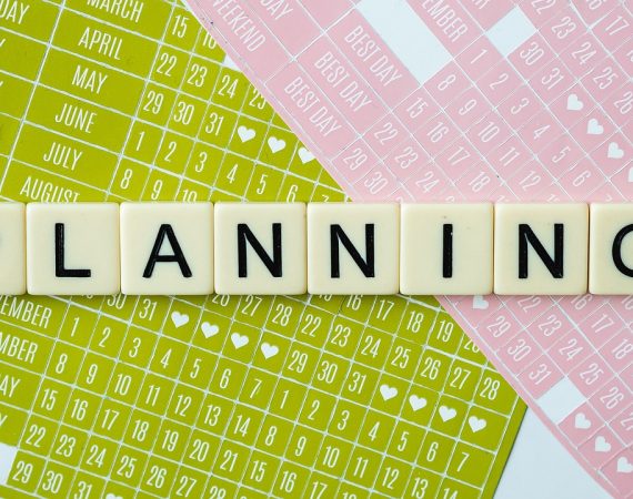 Planning concept with scrabble letters and colourful calendars in background
