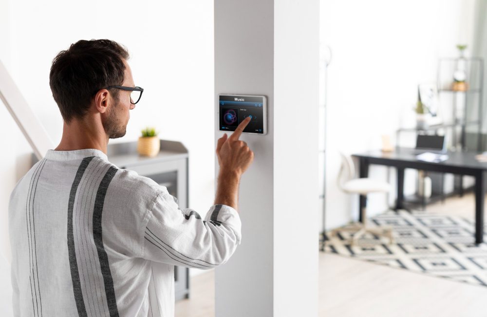 A man interacts with a smart home device app, focused on its screen in a modern living space
