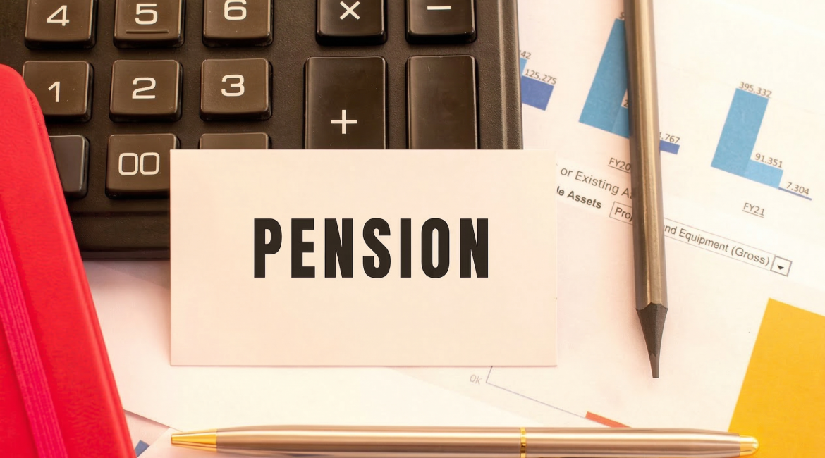 Calculator and financial documents with a pension card and pen on a desk for retirement planning