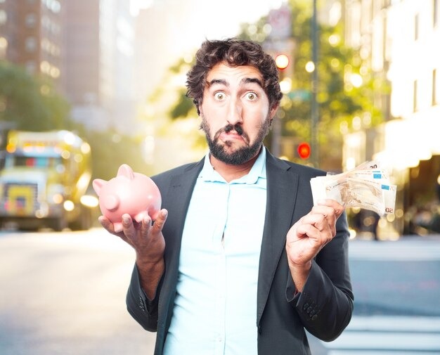 A suited man displays a piggy bank and money, representing financial management and savings